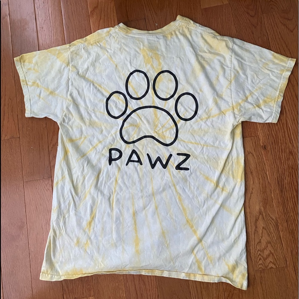 A yellow tie dye pawz t- shirt